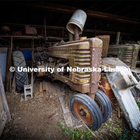 Old tractors rust under the eaves of a shed. Filming of the movie using UNL students as the production crew. Richard Endacott earned multiple awards for his screenplay, "Turn Over." Story about keeping the family farm operating in the modern era as two brothers come together via restoring an old tractor to help fund their operations. August 9, 2023. Photo by Craig Chandler / University Communication.