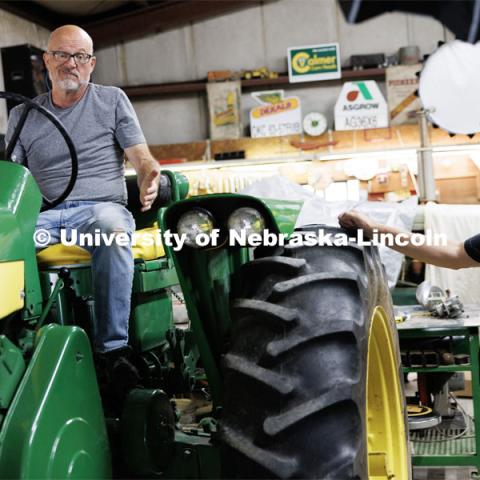 Richard Endacott gestures to producer Jamie Vesay as they discuss whether a restored tractor should be started during the filming. Filming of the movie using UNL students as the production crew. Richard Endacott earned multiple awards for his screenplay, "Turn Over." Story about keeping the family farm operating in the modern era as two brothers come together via restoring an old tractor to help fund their operations. August 9, 2023. Photo by Craig Chandler / University Communication.