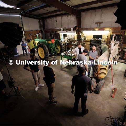 Richard Endacott discusses a scene with brothers Kerry and Thad, played by professional actors Eric Moyer of Lincoln and Calvin Chervinko of Chicago. Filming of the movie using UNL students as the production crew. Richard Endacott earned multiple awards for his screenplay, "Turn Over." Story about keeping the family farm operating in the modern era as two brothers come together via restoring an old tractor to help fund their operations. August 9, 2023. Photo by Craig Chandler / University Communication.