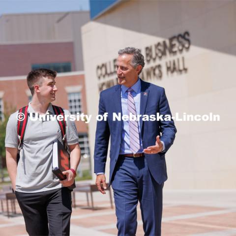 Jack Kinney of Omaha with Richard Moberly, dean of the College of Law, was one of the first Huskers to declare the new interdisciplinary business and law major. Only offered by a handful of business schools, the new major addresses a critical shortage of mid- and upper-level managers with legal knowledge. Kinney and Dean Moberly are pictured walking outside Hawks Hall. August 12, 2023. Photo by Craig Chandler / University Communication and Marketing.