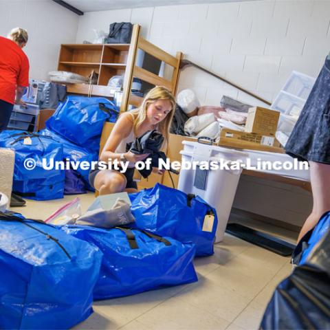 Lily Hurlock unpacks her belongings into their Smith Residence Hall room she shares with her sister, Haven. The two are sharing a room as their sister Montanna (triplets) has a room on another floor in the hall. Sunday early arrival move-in for sorority rush. August 13, 2023. Photo by Craig Chandler / University Communication.