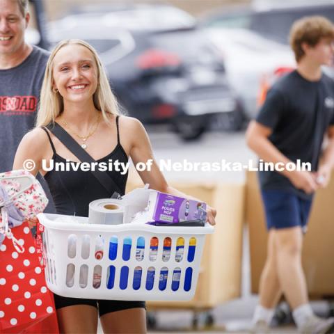 Carley Schroeder of Omaha carries the last of her belongings into Smith Hall. Sunday early arrival move-in for sorority rush. August 13, 2023. Photo by Craig Chandler / University Communication.