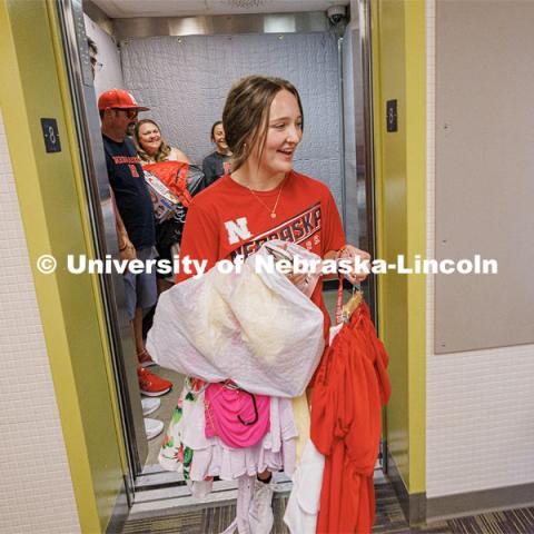 Abby McFarland carries the last of her clothes off the elevator toward her Smith Residence Hall room. Sunday early arrival move-in for sorority rush. August 13, 2023. Photo by Craig Chandler / University Communication.