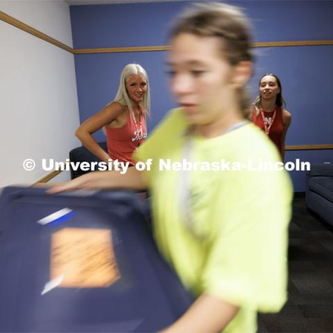 Paige Thompson of Norfolk, left, and Kate-Lynn McNamara of Grand Island watch as their belongings are delivered by the move-in team. Sunday early arrival move-in for sorority rush. August 13, 2023. Photo by Craig Chandler / University Communication.
