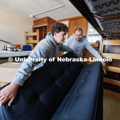 Nick Hauberg and his dad, Kyle, wiggle a futon into place under Nick’s Abel Residence Hall bed. Nick is from Rochester, Michigan, and his dad is a Husker alumnus. Nick is majoring in advertising and public relations. First day of residence hall move-in. August 14, 2023. Photo by Craig Chandler/ University Communication.