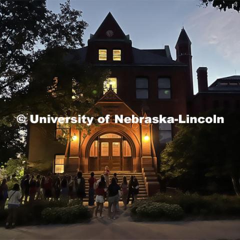 A group of students gathers at Architecture Hall to learn some of the history of the oldest building on campus. Big Red Welcome Night Tour. August 15, 2023. Photo by Deann Gayman / University Communication.