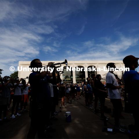 Most of the Cornhusker Marching Band is in the shadows as practice continued until the sun set over campus. The band practices on the greenspace by the Sheldon Art Museum as their normal pregame concert area next to the Kimball Recital Hall is under construction. Cornhusker Marching Band practice. August 16, 2023. Photo by Craig Chandler/ University Communication.