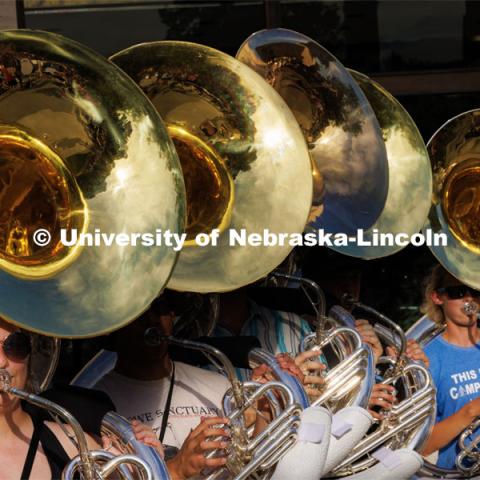 Most of the Cornhusker Marching Band is in the shadows as practice continued until the sun set over campus. The band practices on the greenspace by the Sheldon Art Museum as their normal pregame concert area next to the Kimball Recital Hall is under construction. Cornhusker Marching Band practice. August 16, 2023. Photo by Craig Chandler/ University Communication.