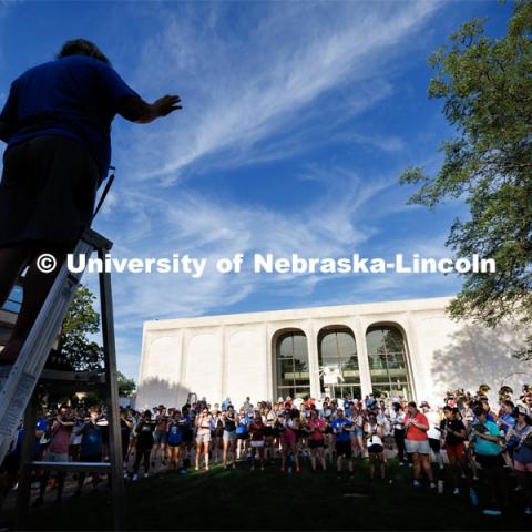 Tony Falcone directs the band practice. The band practices on the greenspace by the Sheldon Art Museum as their normal pregame concert area next to the Kimball Recital Hall is under construction. Cornhusker Marching Band practice. August 16, 2023. Photo by Craig Chandler/ University Communication.