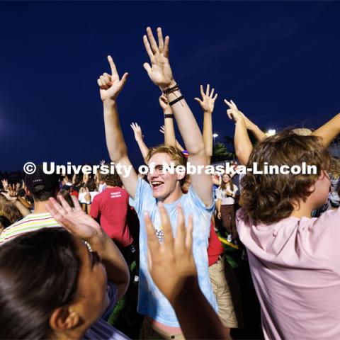 Several hundred students had to organize themselves by the month of their birthday. The July group shouts out to each other. Students at Playfair on the Vine Street Fields Wednesday night. Playfair is called the ultimate ice breaker. The MC leads the students through quick instructions, so students meet others they don’t know. They organize quickly in groups by birth month, number of family members, number of pets, anything to get students talking with each other. Playfair is part of Big Red Welcome. August 16, 2023. Photo by Craig Chandler/ University Communication. 