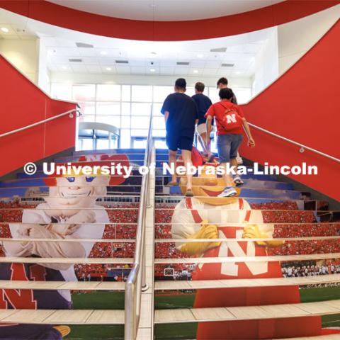 Students climb the stairs as Herbie Husker and Lil’ Red hang out on the steps leading up from the bookstore in the Nebraska Union. August 16, 2023. Photo by Craig Chandler/ University Communication.