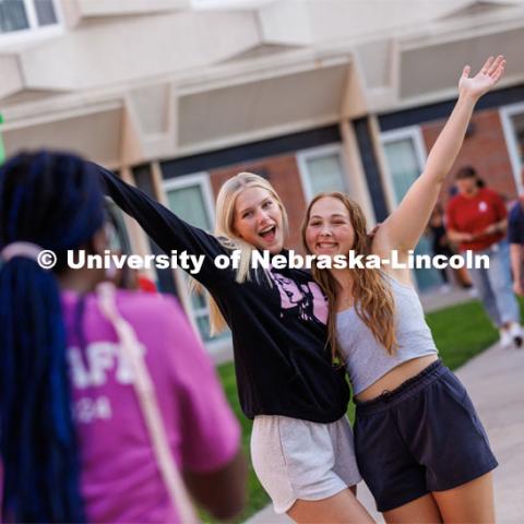 Avery Kardell of Omaha and Macy Martin of Omaha pose for a Polaroid snapshot taken by RAs at the Block party at Harper Schramm Smith. August 17, 2023. Photo by Craig Chandler / University Communication.