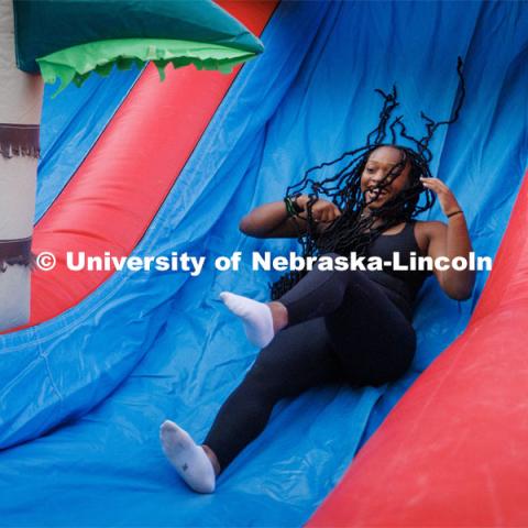 Students slide down the inflatables at the Block party at Harper Schramm Smith. August 17, 2023. Photo by Craig Chandler / University Communication.