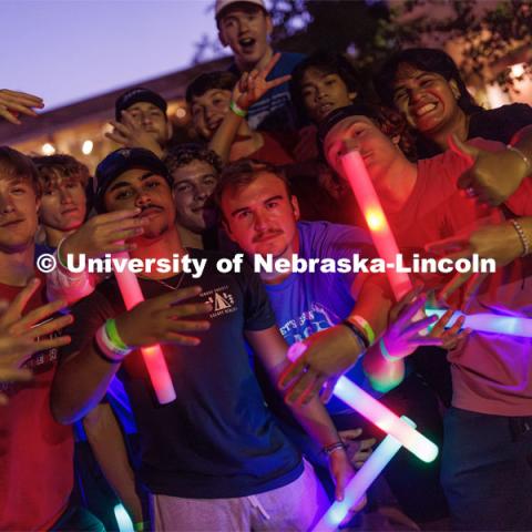 Decked out with glow sticks, students dance at the Block party at Harper Schramm Smith. August 17, 2023. Photo by Craig Chandler / University Communication.