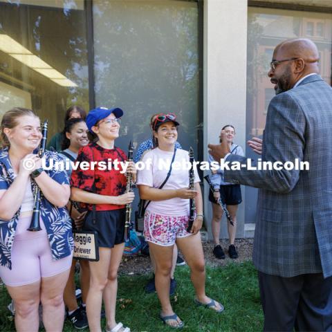 Chancellor Rodney Bennett talks with the clarinet section of the Cornhusker Marching Band during a break in their practice. August 17, 2023. Photo by Craig Chandler/ University Communication.
