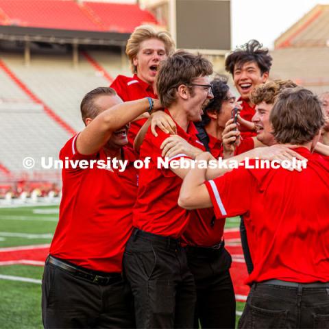 Gavin Addleman celebrates with his section after winning the famous "drill down". Big Red Welcome week featured the Cornhusker Marching Band Exhibition in Memorial Stadium where they showed highlights of what the band has been working on during their pre-season Band Camp, including their famous “drill down”. August 18, 2023. Photo by Sammy Smith / University Communication.