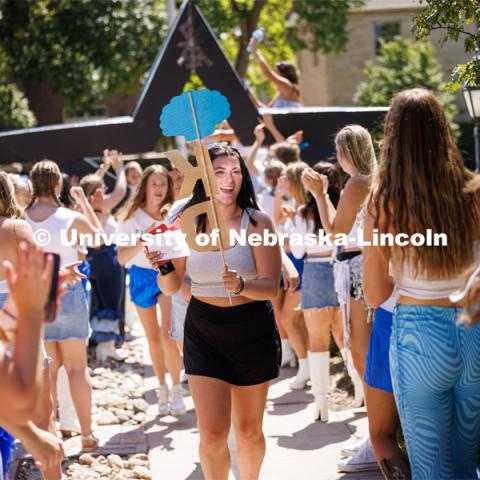 Ava Koziel runs into the Kappa Delta sorority after receiving her bid Saturday afternoon. Sorority Bid Day in the Cather Dining Complex and on the Vine Street Fields. August 19, 2023. Photo by Craig Chandler / University Communication.