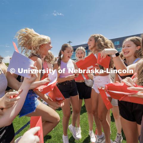 New sorority members react as they open their bid cards Saturday. Sorority Bid Day in the Cather Dining Complex and on the Vine Street Fields. August 19, 2023. Photo by Craig Chandler / University Communication.