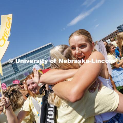 Kylie Lancaster, one of the newest members of the Chi Omega sorority receives a welcoming hug. Sorority Bid Day in the Cather Dining Complex and on the Vine Street Fields. August 19, 2023. Photo by Craig Chandler / University Communication.