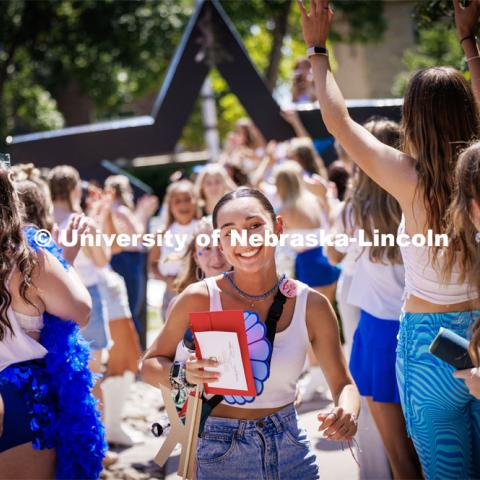 Mia Perales runs into the Kappa Delta sorority after receiving her bid Saturday afternoon. Sorority Bid Day in the Cather Dining Complex and on the Vine Street Fields. August 19, 2023. Photo by Craig Chandler / University Communication.