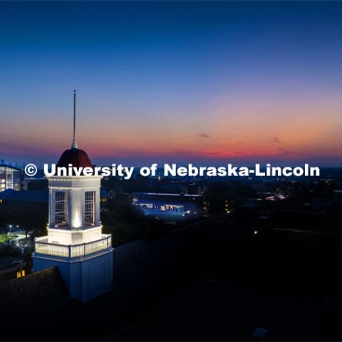 The cupola on Love Library glows at dawn as the sun rises on the First day of classes of fall semester. August 21, 2023 Photo by Craig Chandler / University Communication. 