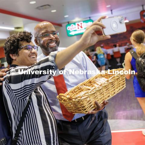 Chancellor Rodney Bennett poses with Rashedul Hasan during the chancellor’s cookie giveaway in the Nebraska Union. First day of classes for fall semester.