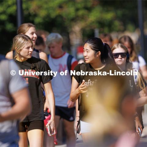 Brooklynn Hunke, a freshman from Gretna, Nebraska, talks with Misora Okuoka, a sophomore international student from Japan, Tuesday morning as they leave their Pound Hall class. Students walk on campus in-between Pound Hall and Love Library. The university’s latest annual census shows a 3.6% increase in first-time freshmen from Nebraska. September 5, 2023. Photo by Craig Chandler/ University Communication.