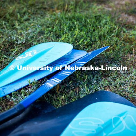 UNL Campus Rec Center’s Paddleboard oars lay in the grass at Branched Oak Lake. About Lincoln - Paddleboarding at Branched Oak Lake with Campus Rec. September 13, 2023. Photo by Kristen Labadie / University Communication.