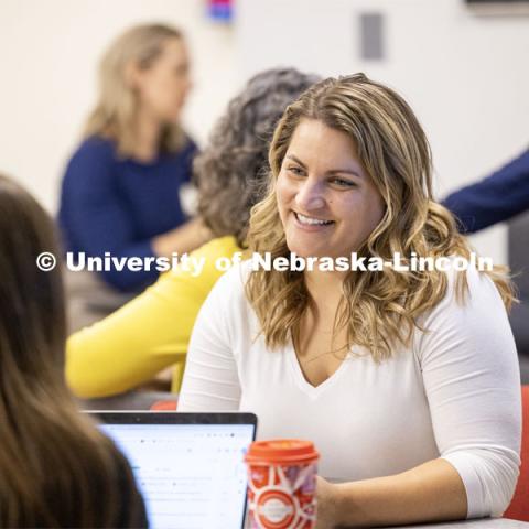 Law student smiles as they talk to another student. College of Law photo shoot. September 14, 2023. Photo by Craig Chandler / University Communication