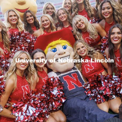 Herbie Husker poses with the Scarlets dance team. Northern Illinois football in Memorial Stadium. September 16, 2023. Photo by Craig Chandler / University Communication.