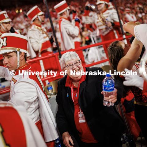 Rose Johnson with the Cornhusker Marching Band hands out water to the band members as they return to the stands following the half time show. Northern Illinois football in Memorial Stadium. September 16, 2023. Photo by Craig Chandler / University Communication.