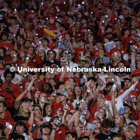 Husker fans light up the night during the light show between the 3rd and 4th quarters. Northern Illinois football in Memorial Stadium. September 16, 2023. Photo by Craig Chandler / University Communication.