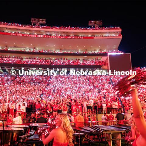 Husker fans light up the night during the light show between the 3rd and 4th quarters. Northern Illinois football in Memorial Stadium. September 16, 2023. Photo by Craig Chandler / University Communication.