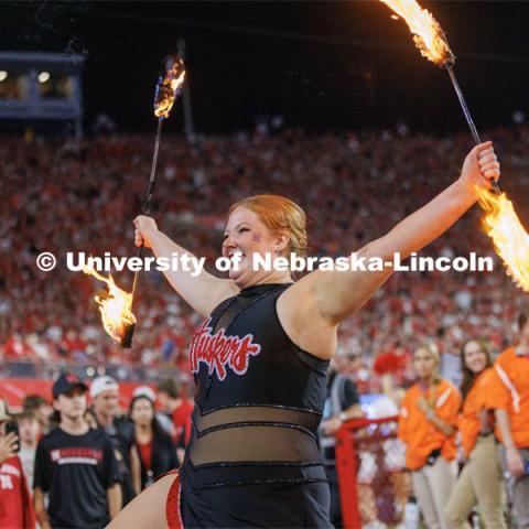 One of the twirlers for the Cornhusker Marching Band twirls flaming batons. Northern Illinois football in Memorial Stadium. September 16, 2023. Photo by Craig Chandler / University Communication.