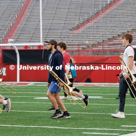 Cornhusker Marching Band runs onto the field during their early morning practice. September 19, 2023. Photo by Craig Chandler / University Communication.