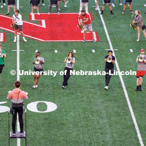 The horn section leans into their blues music. Cornhusker Marching Band early morning practice. September 19, 2023. Photo by Craig Chandler / University Communication.