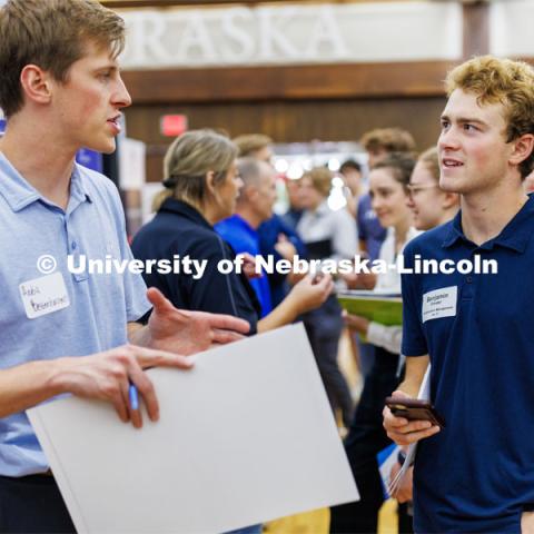 Benjamin Ernster talks with a recruiter for JE Dunn construction at the Career Fair in the Nebraska Union. September 20, 2023. Photo by Craig Chandler / University Communication.