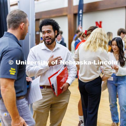 Eldwin Caballero talks with a recruiter for Kiewit at the Career Fair in the Nebraska Union. September 20, 2023. Photo by Craig Chandler / University Communication.