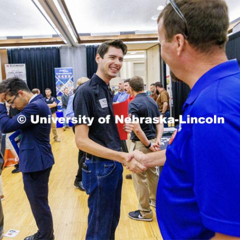 Michael Bates talks with a recruiter for Chief construction at the Career Fair in the Nebraska Union. September 20, 2023. Photo by Craig Chandler / University Communication.