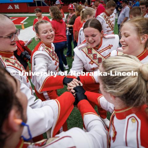 The Husker cymbal line huddles before taking the field for pregame. Nebraska football vs. Louisiana Tech. August 23, 2023. Photo by Craig Chandler/ University Communication.