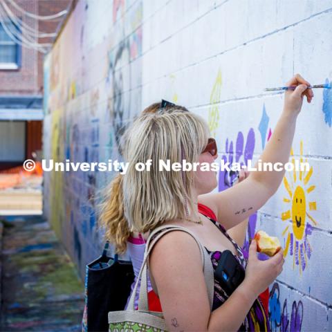 Painting in the art alley at the Lux Street Art Festival. About Lincoln – Lux Street Art Festival. September 24, 2023. Photo by Kristen Labadie / University Communication.