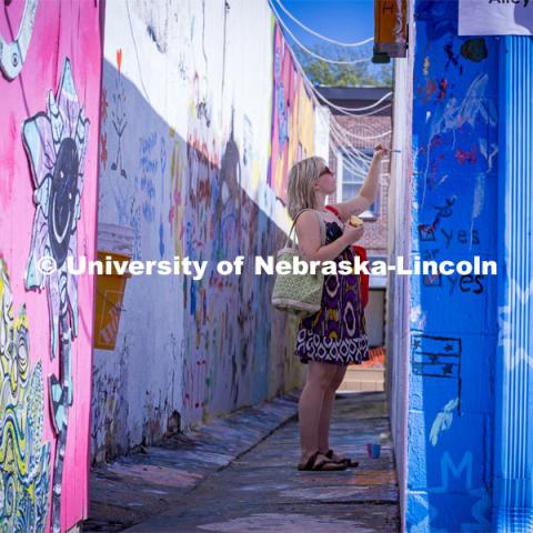 Painting in the art alley at the Lux Street Art Festival. About Lincoln – Lux Street Art Festival. September 24, 2023. Photo by Kristen Labadie / University Communication.