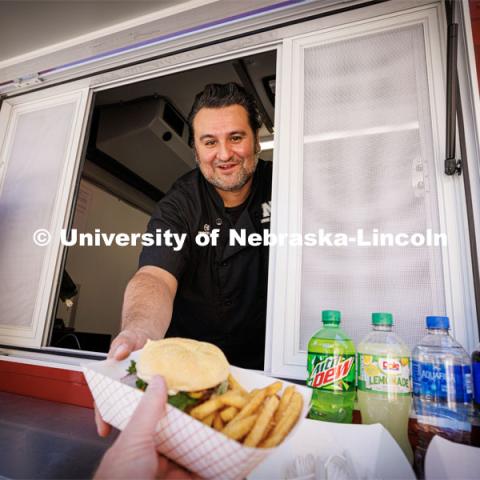 Octavio “Otto” Meza, Production Manager, for Housing and Dining Services, waits on customers to the Harper’s Smokehouse Food Truck parked outside Avery Hall.  September 28, 2023. Photo by Craig Chandler / University Communication.