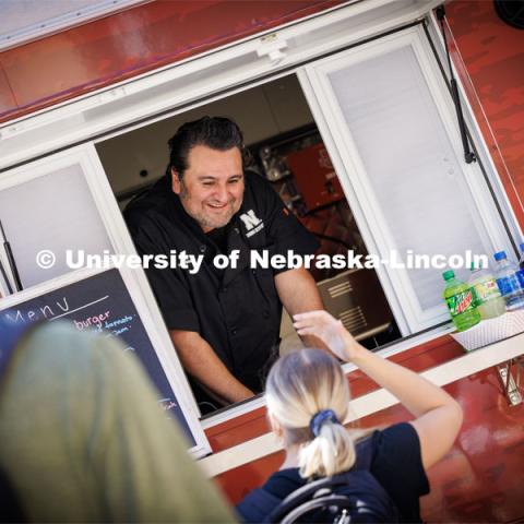 Octavio “Otto” Meza, Production Manager, for Housing and Dining Services, waits on customers to the Harper’s Smokehouse Food Truck parked outside Avery Hall.  September 28, 2023. Photo by Craig Chandler / University Communication.
