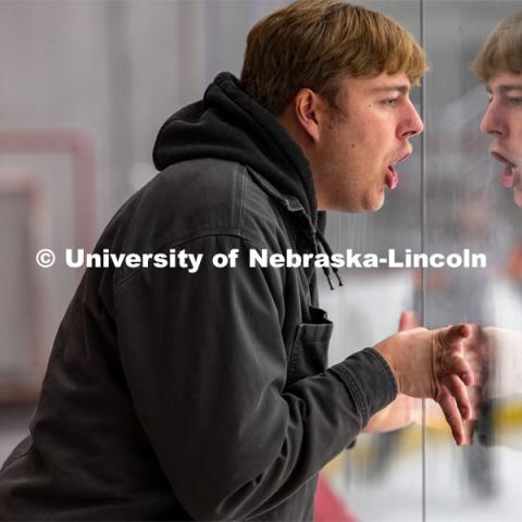 Fan leans against the plexiglass and shouts after hockey player misses goal. Husker Hockey at Breslow Ice Hockey Center. October 7, 2023. Photo by Dillon Galloway for University Communication and Marketing.