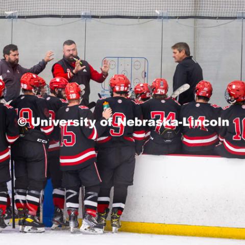 Players gather close to listen to the coach. Husker Hockey at Breslow Ice Hockey Center. October 7, 2023. Photo by Dillon Galloway for University Communication and Marketing.