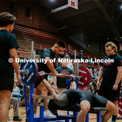 David Ho, Junior, giving a lift off for athlete Dax Duncan, freshman, during the bench event in the Strong Husker Powerlifting meet held in the Coliseum, hosted by UNL Barbell Club. October 7, 2023. Photo by Jonah Tran / University Communication