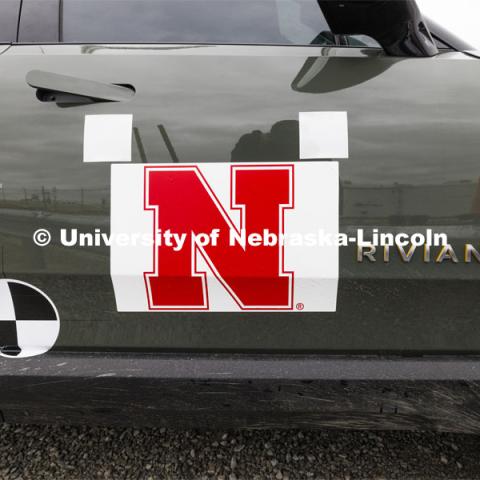 The Rivian truck has decals affixed to the sides and top to make it easier for the data to be used that the cameras capture. In research sponsored by the U.S. Army Engineer Research and Development Center, the University of Nebraska-Lincoln’s Midwest Roadside Safety Facility is investigating the safety and military defense questions raised by the burgeoning number of electric vehicles on the nation’s roadways. crash test performed on a guardrail on October 12, 2023, highlighted the concern. At 60 mph, the 7,000-plus-pound, 2022 Rivian R1T truck tore through a commonly used guardrail system with little reduction in speed. October 12, 2023. Photo by Craig Chandler / University Communication and Marketing.