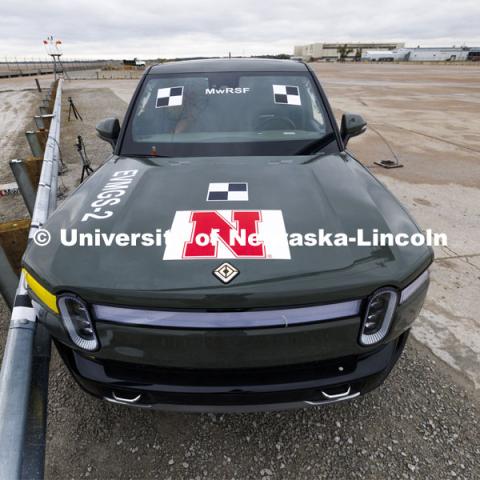 The Rivian truck has decals affixed to the sides and top to make it easier for the data to be used that the cameras capture. In research sponsored by the U.S. Army Engineer Research and Development Center, the University of Nebraska-Lincoln’s Midwest Roadside Safety Facility is investigating the safety and military defense questions raised by the burgeoning number of electric vehicles on the nation’s roadways. crash test performed on a guardrail on October 12, 2023, highlighted the concern. At 60 mph, the 7,000-plus-pound, 2022 Rivian R1T truck tore through a commonly used guardrail system with little reduction in speed. October 12, 2023. Photo by Craig Chandler / University Communication and Marketing.