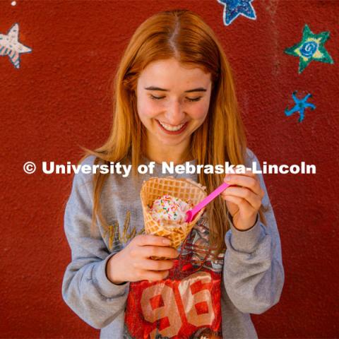 Hannah-Kate Kinney enjoys a waffle cone at Ivanna Cone. About Lincoln at Ivanna Cone in the Haymarket. October 20, 2023. Photo by Matthew Strasburger / University Communication.